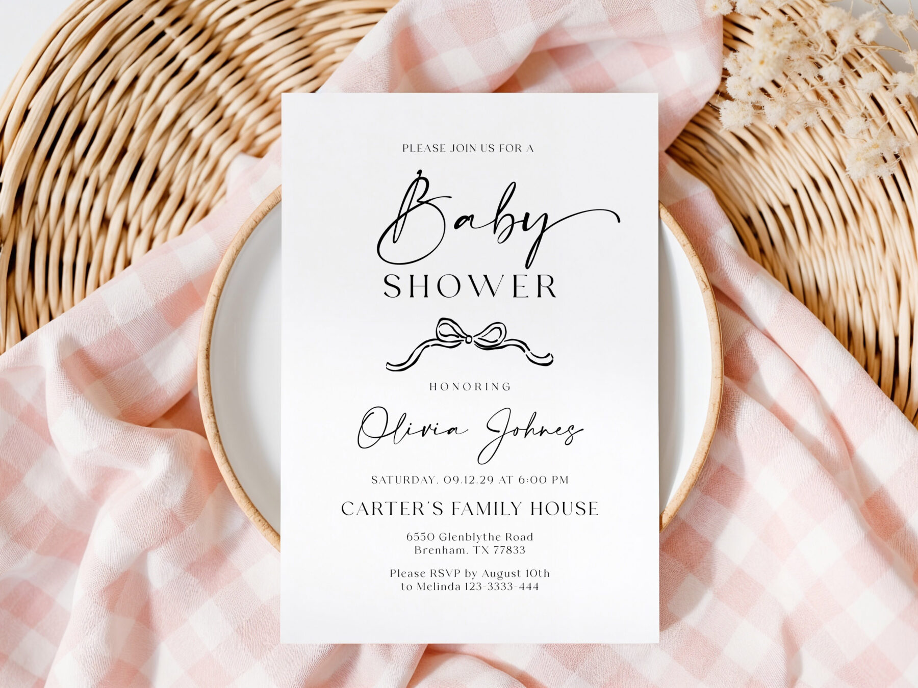 Baby Shower Invitation - Bow Detail. A fine black bow below the baby shower heading, with script names and small serif event details.