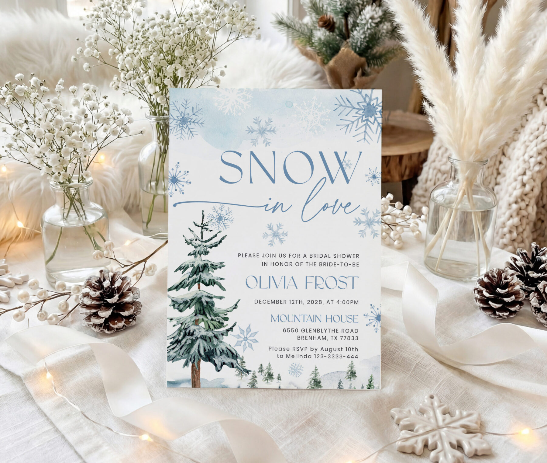 Snow in Love Blue Winter Bridal Shower Invitation. Snow in Love wording with blue snowflakes and evergreen trees.